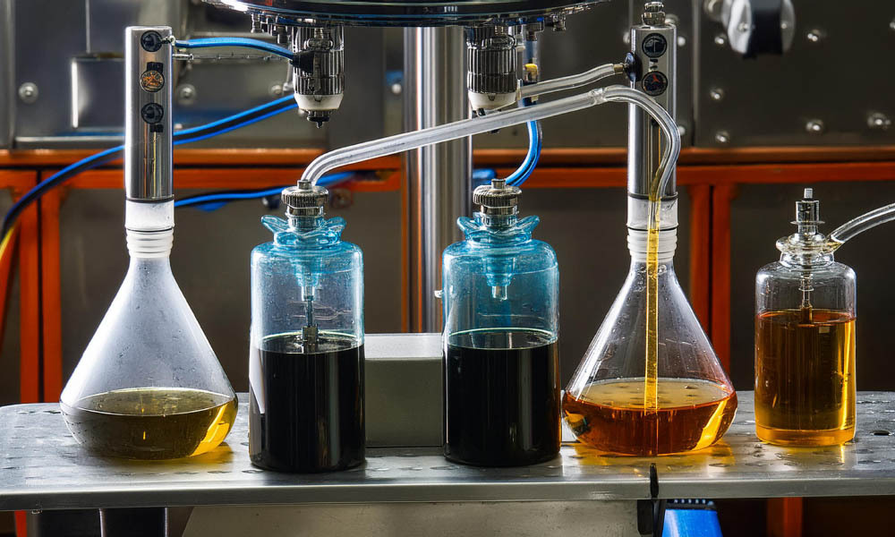 use of lab gear (different glass beakers) during the thca distillate process. Jars full of distillate